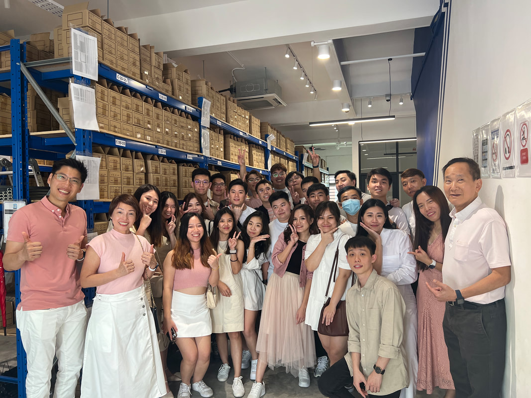 The team together in the warehouse at a company event