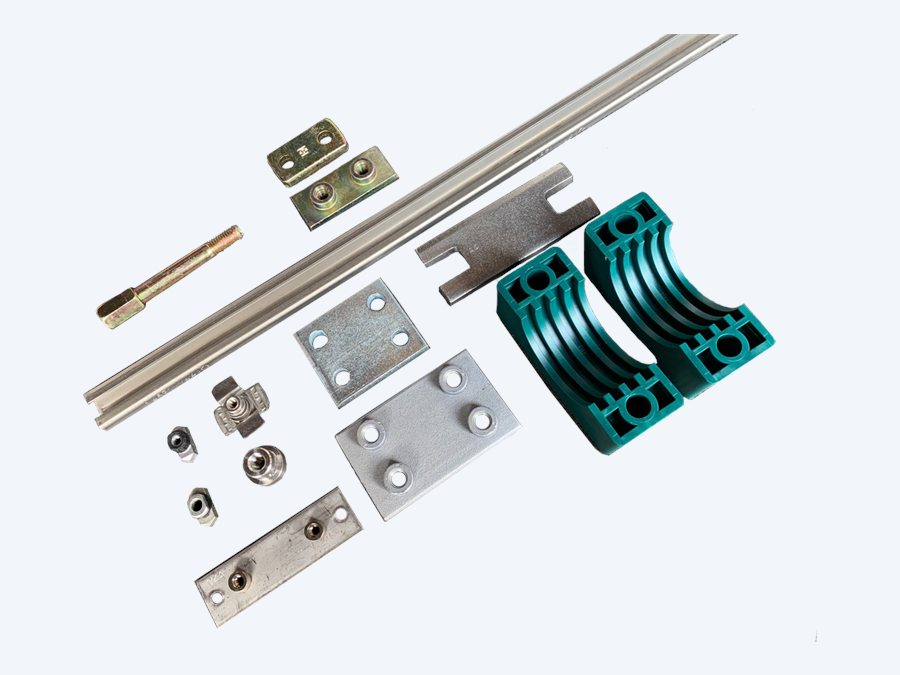 STAUFF pipe clamp system laid out: mounting rail, hexagon rail nuts, stacking bolt, safety locking plate, base and top plates, and two green polypropylene clamp halves